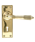 From The Anvil's Aged Brass Reeded Lever Lock Set