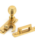 From The Anvil's Polished Brass Beehive Sash Hook Fastener