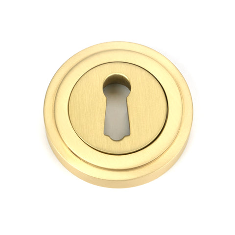From The Anvil's Satin Brass Round Escutcheon