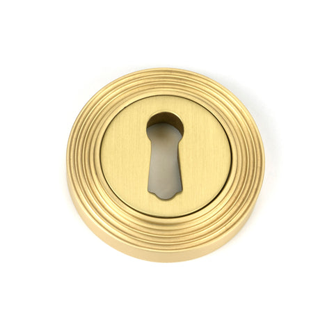 From The Anvil's Satin Brass Round Escutcheon