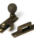 From The Anvil's Burnished Brass Beehive Sash Hook Fastener